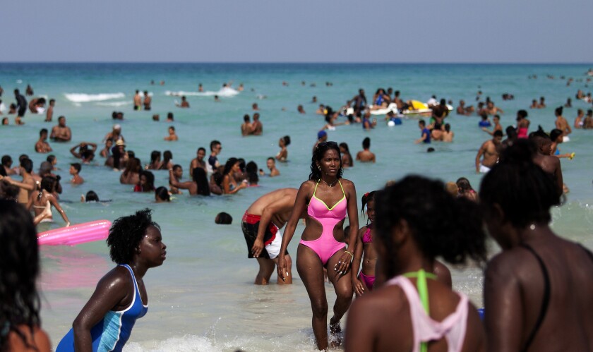 Cubans on Santa Maria del Mar beach near Havana. They can spend as much time as they wish on the beach but not so for U.S. citizens. (Brian van der Brug / Los Angeles Times)