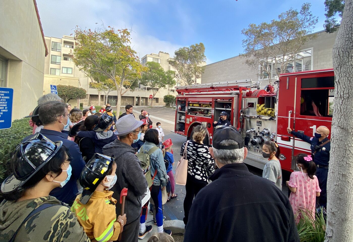 Firefighters from La Jolla's Station 13 explain their equipment during a visit to the La Jolla/Riford Library.