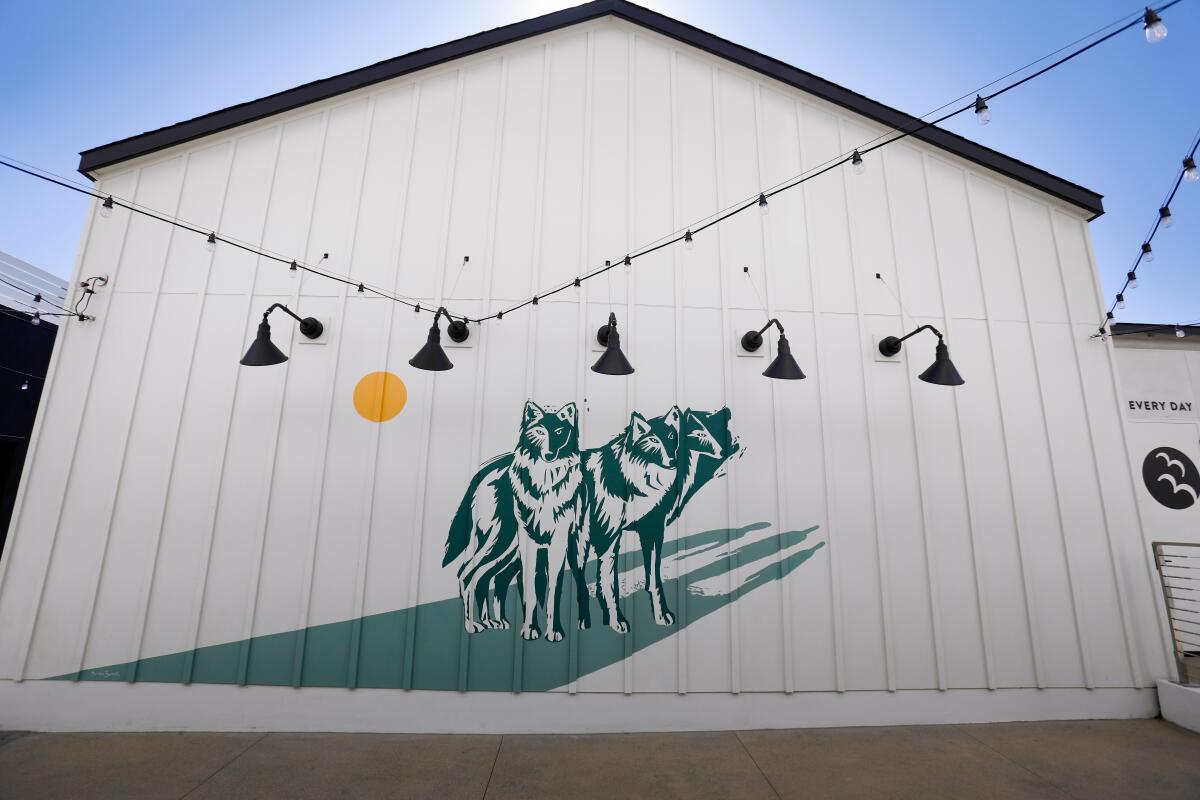 "Wolves" by artist Natalie Bessell is on the side of the Urban Beach House at One Paseo.