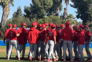 Harvard-Westlake players congratulate pitcher Avery Thau after his shutout over La Mirada 9-0.