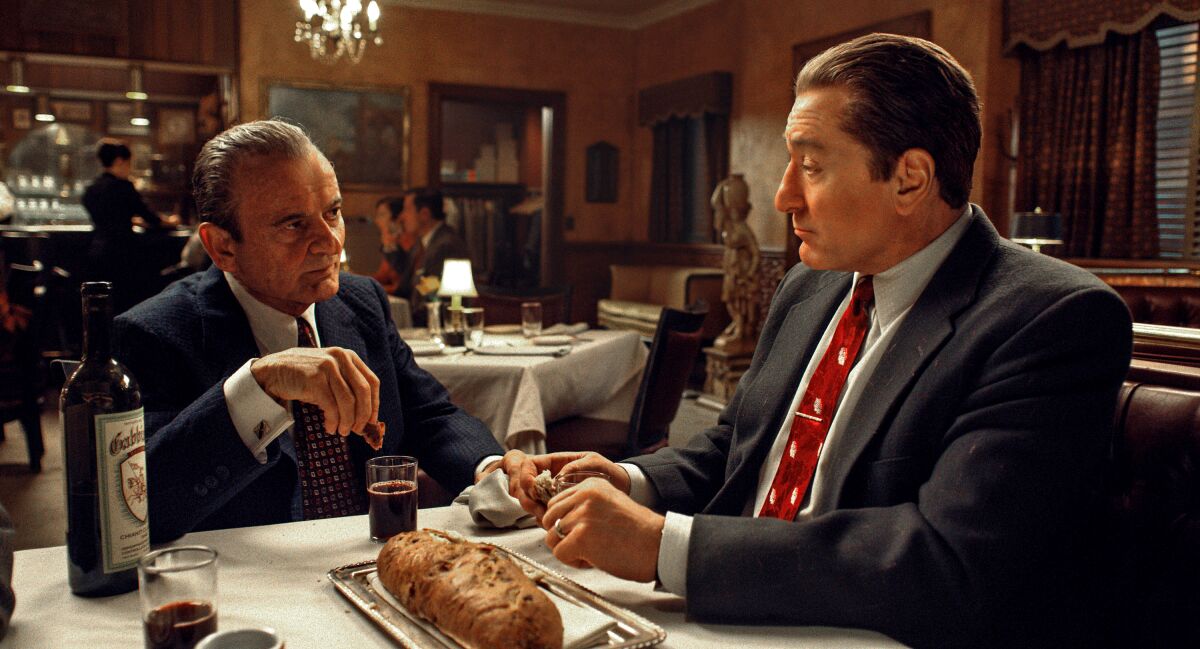 Two men sitting at a table in a restaurant