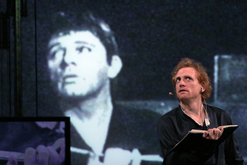 Scott Shepherd, right, next to an image of Richard Burton in the background, in the Wooster Group's Hamlet". Photo by Paula Court.
