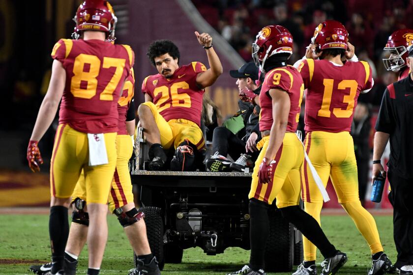 USC running back Travis Dye is carted off the field after a leg injury against Colorado in the second quarter Nov. 11, 2022.