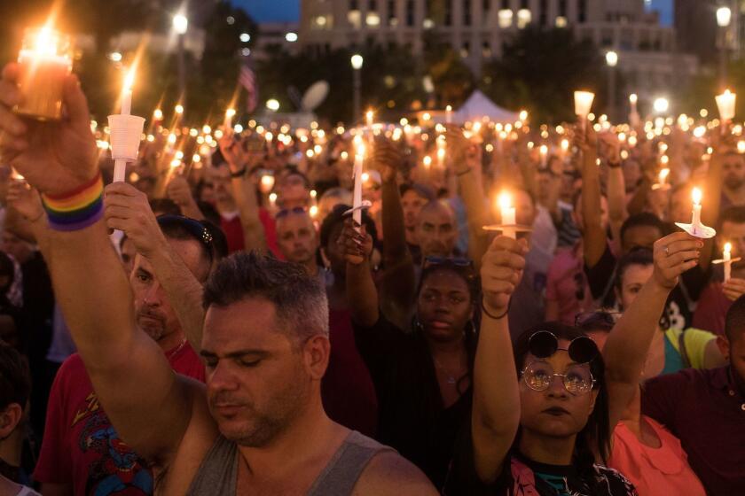 ORLANDO, FL - JUNE 13: People hold candles during an evening memorial service for the victims of the Pulse Nightclub shootings, at the Dr. Phillips Center for the Performing Arts, June 13, 2016 in Orlando, Florida. The shooting at Pulse Nightclub, which killed 49 people and injured 53, is the worst mass-shooting event in American history. (Photo by Drew Angerer/Getty Images) ** OUTS - ELSENT, FPG, CM - OUTS * NM, PH, VA if sourced by CT, LA or MoD **