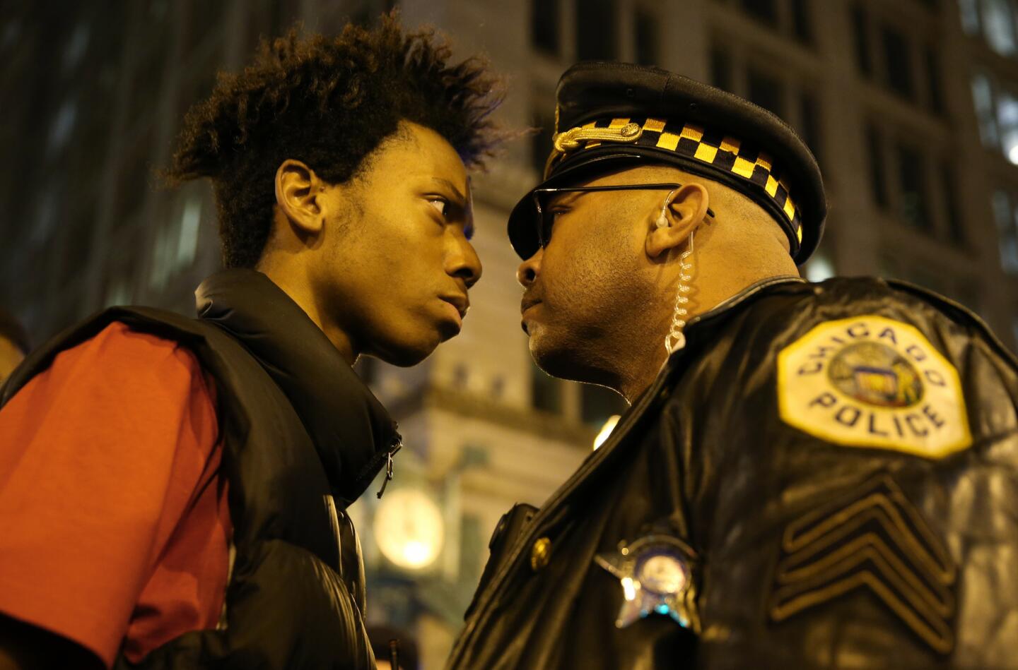 Lamon Reccord stares down a police officer during a march against police violence at State and Randolph streets on Nov. 25, 2015.