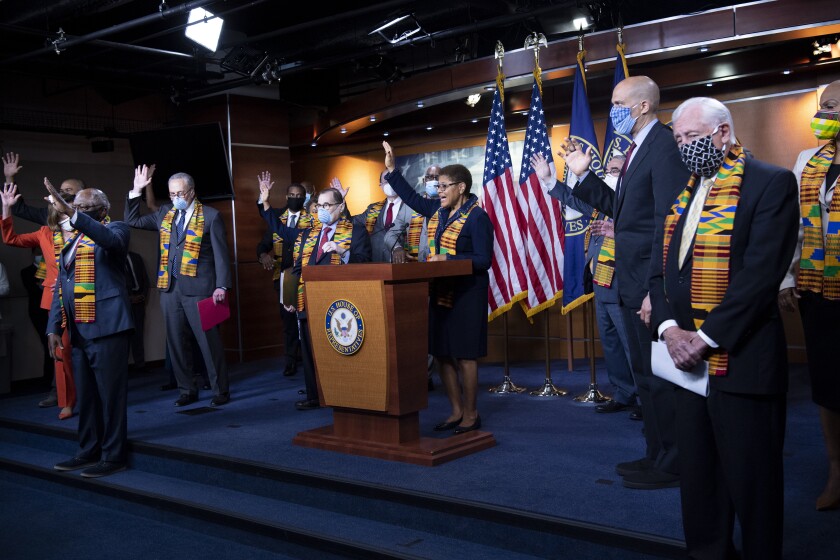 UNITED STATES - JUNE 8: Rep. Karen Bass, D-Calif., and other members of Congress raise their hands in response to a reporters question during a press conference to unveil policing reform and equal justice legislation in Washington on Monday, June 8, 2020. (Photo by Caroline Brehman/CQ Roll Call via AP Images)
