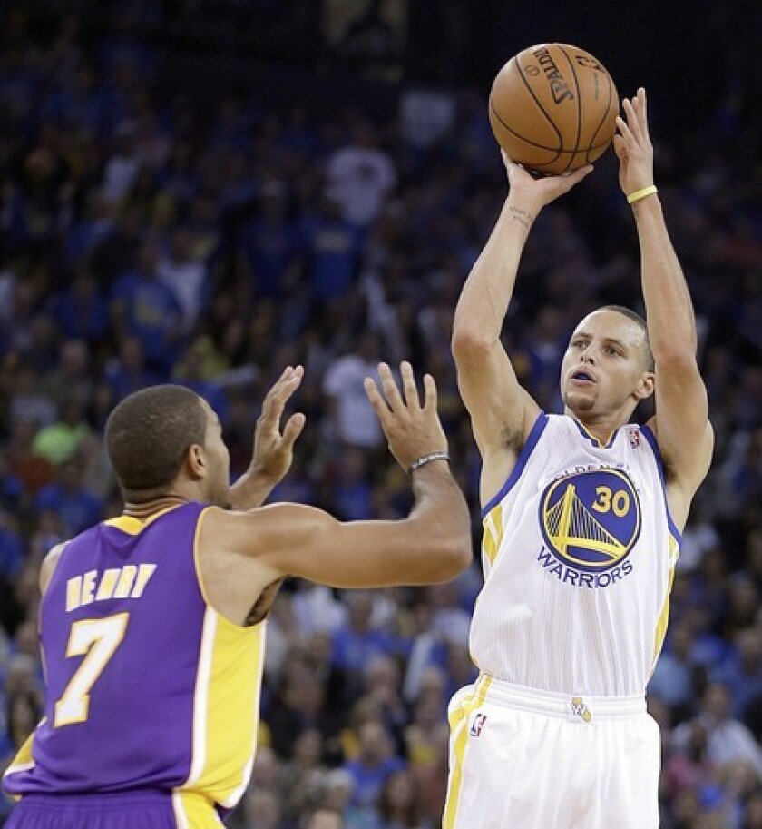 Lakers forward Xavier Henry arrives too late to challenge a shot by Warriors point guard Stephen Curry in Oakland.