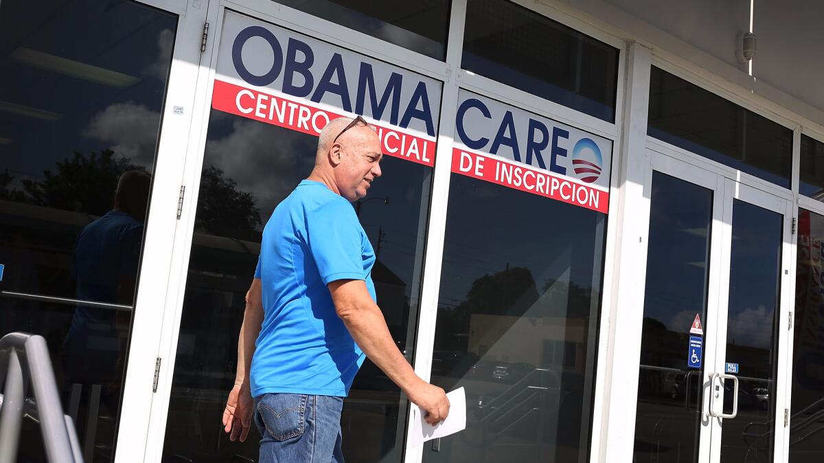 Alberto Abin walks out of the UniVista Insurance company office after shopping for a health plan under the Affordable Care Act, also known as Obamacare.