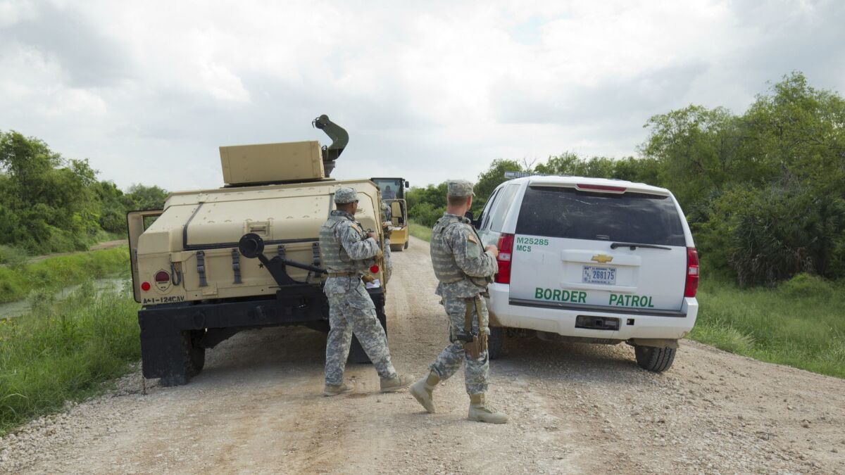 National Guard troops do a shift change on the Rio Grande levee near Anzalduas Park in Granjeno, Texas.