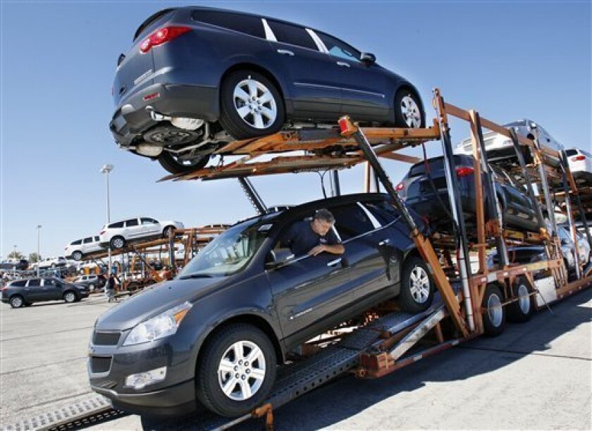In this Oct. 3, 2008 file photo, Car-Transport Tom Landwehr of Murfreesboro, Tenn., loads new 2009 Chevrolet Traverse vehicles at the General Motors Spring Hill Manufacturing Plant in Spring Hill, Tenn. With their employers poised to announce billions more in losses and further job cuts on Friday, Nov. 7, 2008, it's worry time once again at General Motors Corp. and Ford Motor Co. factories across the country. (AP Photo/Bill Waugh, file)