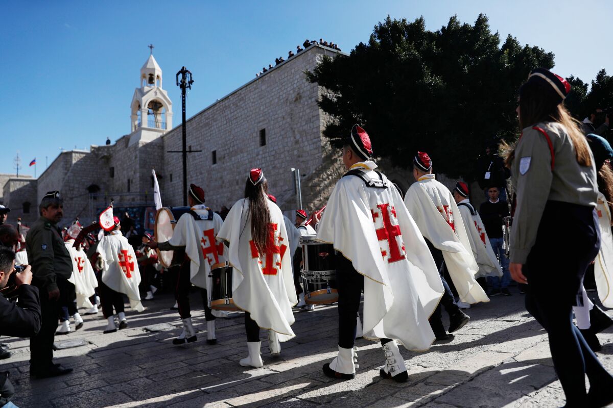 Christian scouts take part in a Christmas Eve procession at Manger Square, leading to the Church of the Nativity, the traditionally accepted birthplace of Jesus Christ, in the West bank town of Bethlehem.