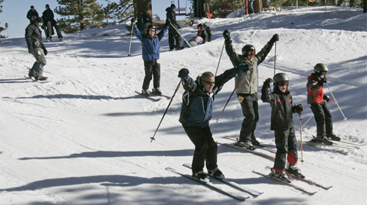 DELIGHTED: Skiers cheer as they head to an upper lift at the Mt. Waterman resort. The resort lacks snow-making equipment, but it faces north, keeping the sun's rays from melting the snow as quickly as can happen at other ski facilities.