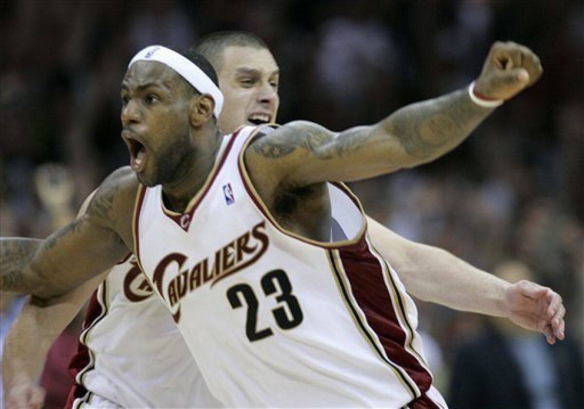 Cleveland Cavaliers' LeBron James (23) celebrates after his 3-point shot at the buzzer beat the Orlando Magic 96-95 in Game 2 of the NBA Eastern Conference basketball finals Friday, May 22, 2009, in Cleveland. (AP Photo/Tony Dejak)