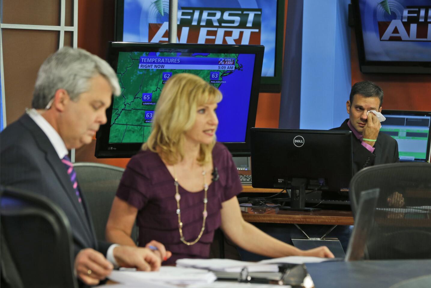 WDBJ meteorologist Leo Hirsbrunner, right, gets emotional during the early morning newscast as anchors deliver the news Aug. 27, 2015, the day after a reporter and cameraman were killed during a live broadcast.