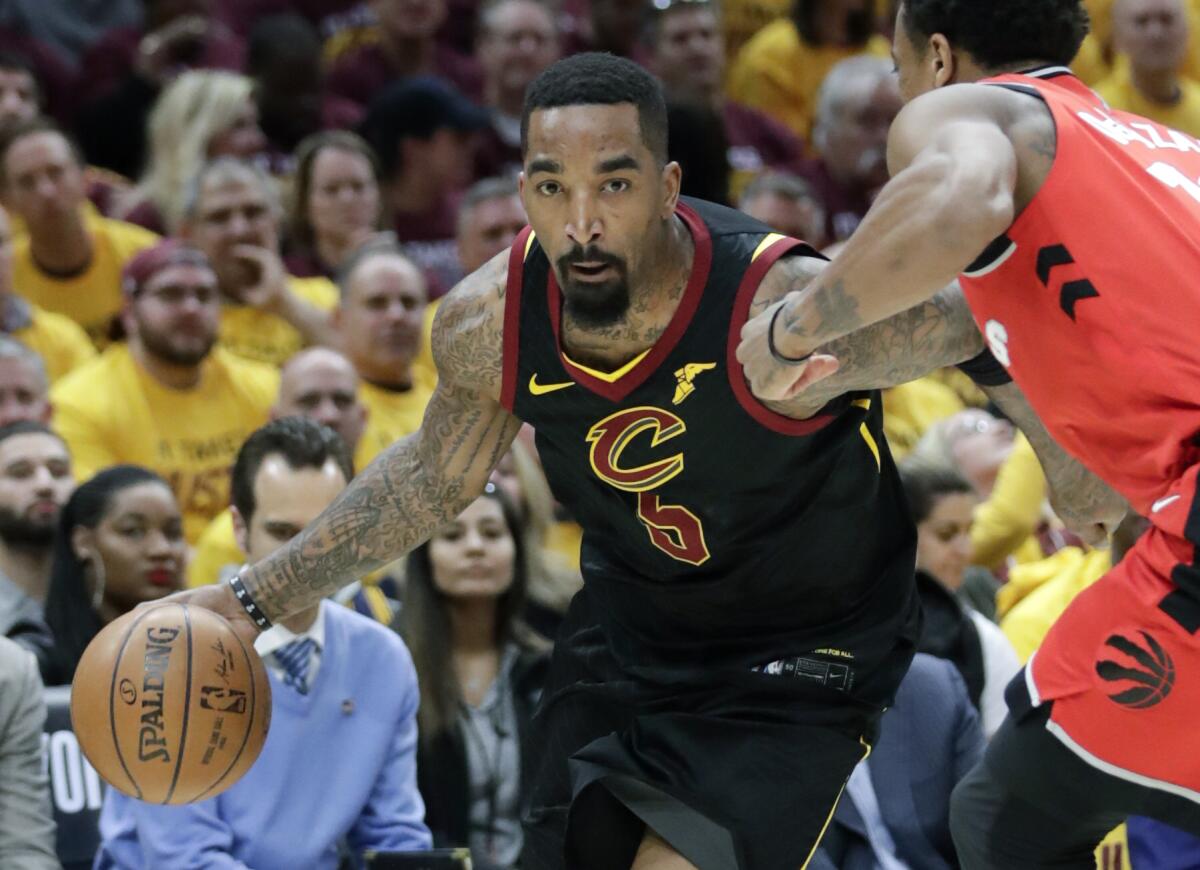 JR Smith drives past DeMar DeRozan during a game between the Cavaliers and Raptors.