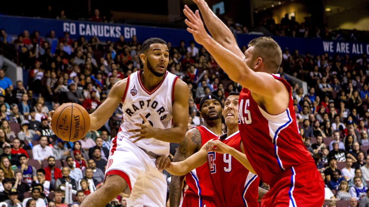 Raptors guard Cory Joseph has his drive cut off by Clippers newcomers Cole Aldrich (45) and Pablo Prigioni (9) during their exhibition game Sunday night in Vancouver.