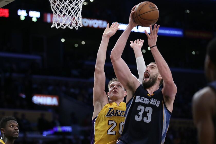 Memphis Grizzlies center Marc Gasol gets past Lakers center Timofey Mozgov during second half action on Tuesday.