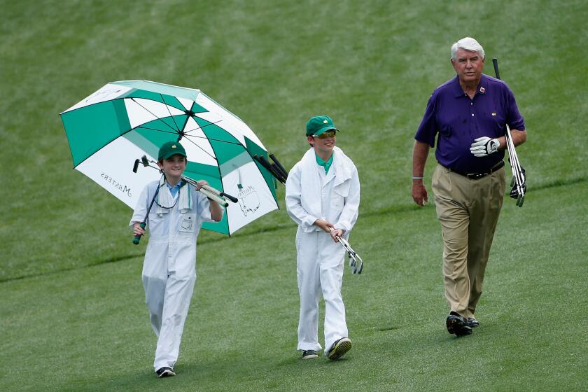 AUGUSTA, GA - APRIL 08: Charles Coody walks with two young caddies during the Par 3 Contest prior to the start of the 2015 Masters Tournament at Augusta National Golf Club on April 8, 2015 in Augusta, Georgia. (Photo by Ezra Shaw/Getty Images)