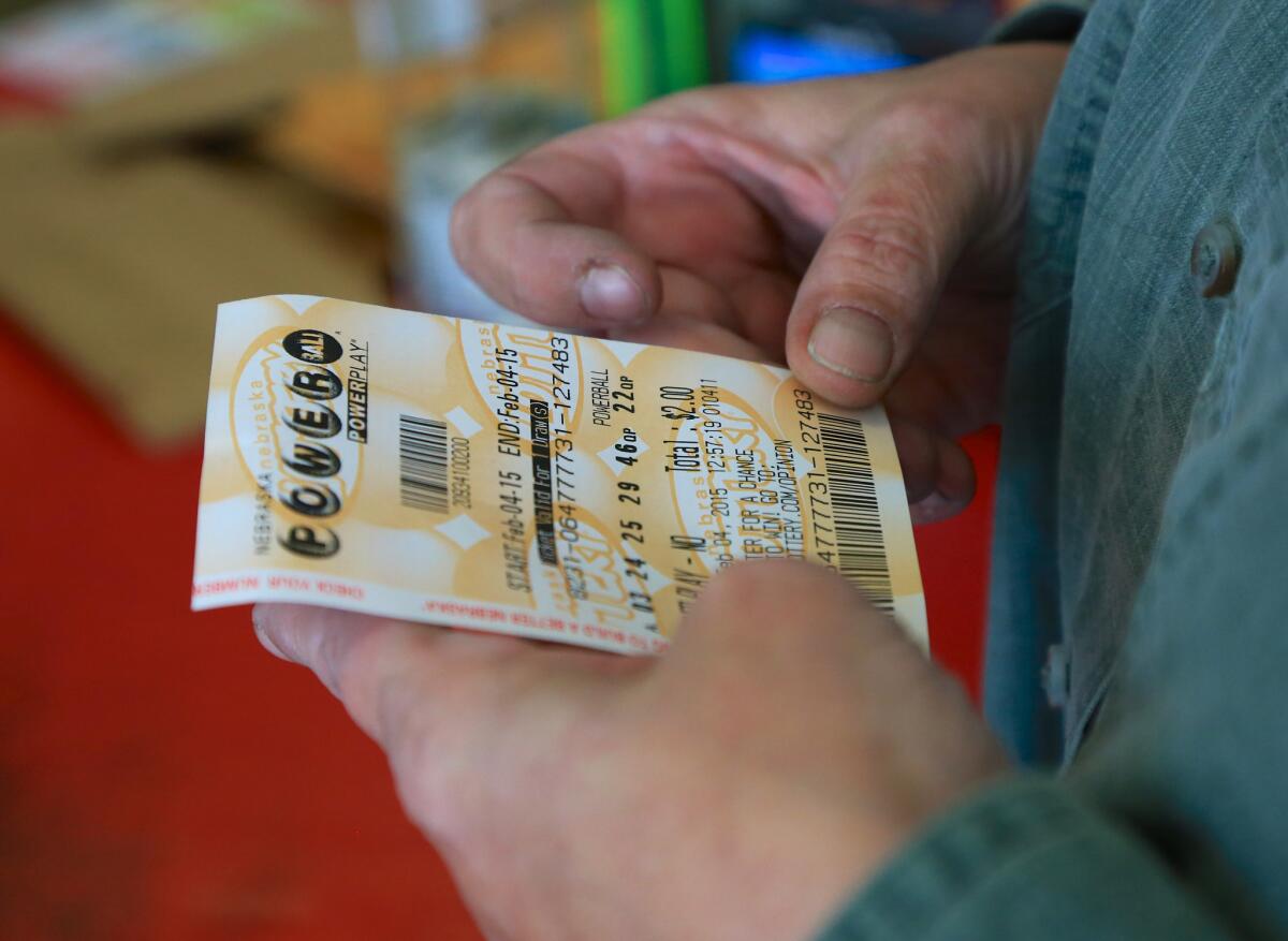 A customer inspects the Powerball ticket she purchased at a U-Stop store in Lincoln, Neb., on Wednesday. She didn't win the jackpot.