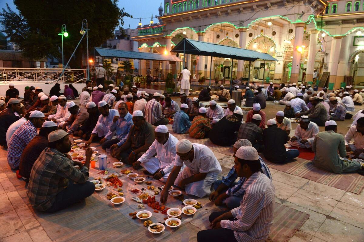 Indian Muslims break their fast during the holy month of Ramadan at Jama Masjid Mahaboob Chowk in Hyderabad on July 18.