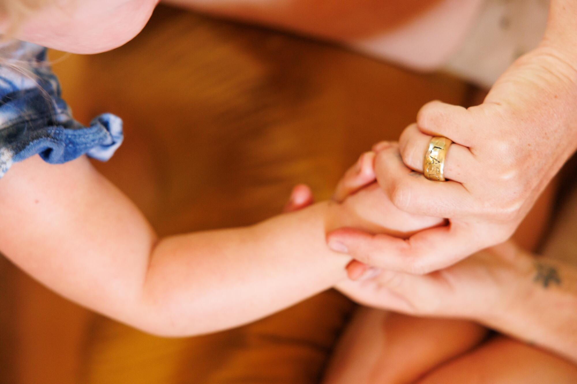 La Rue holds her daughter's hand.