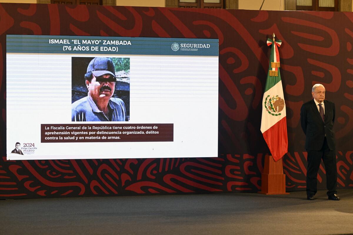 Mexico's president stands onstage during a news conference.