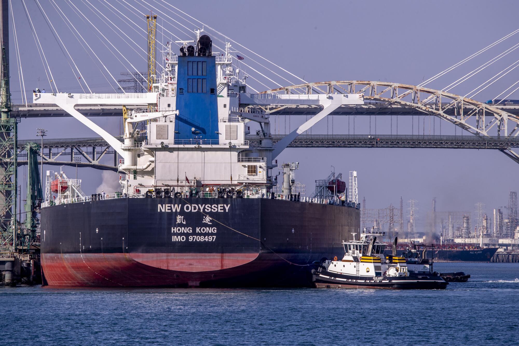 Tugboat Delta Audrey begins to pull the supertanker from Pier 121 in the Port of Long Beach out to sea.
