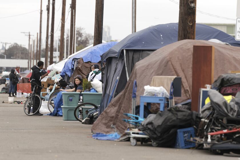 SAN DIEGO, CA - JANUARY 31, 2022: A row of tents at a homeless encampment on Sports Arena Boulevard in San Diego on Monday, January 31, 2022. (Hayne Palmour IV / For The San Diego Union-Tribune)