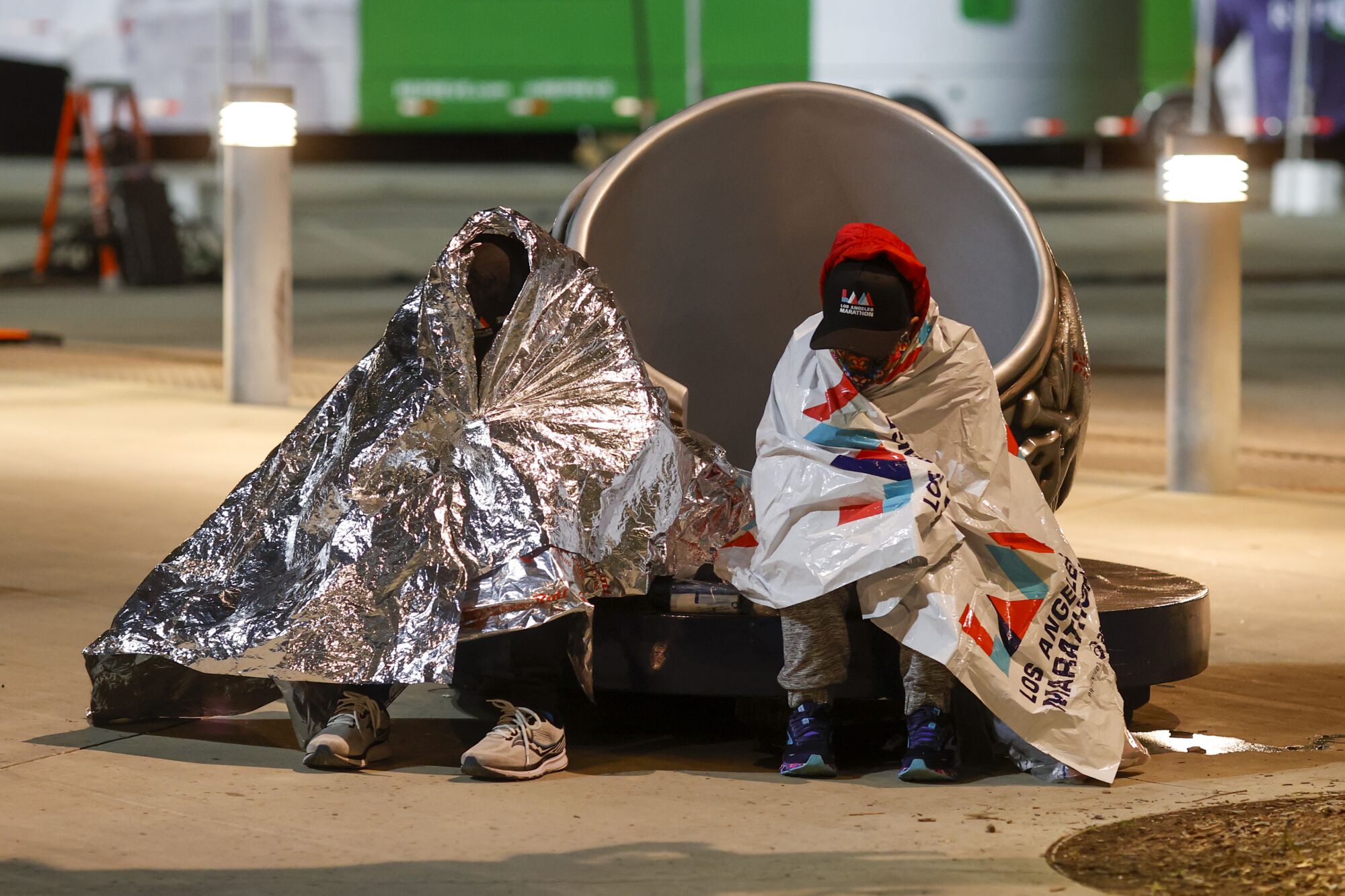 Two runners are wrapped in blankets at Dodger Stadium.