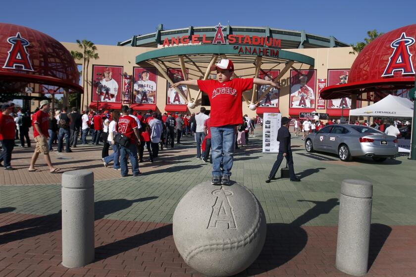 A young fan has some fun before entering Angel Stadium for a game in 2013.
