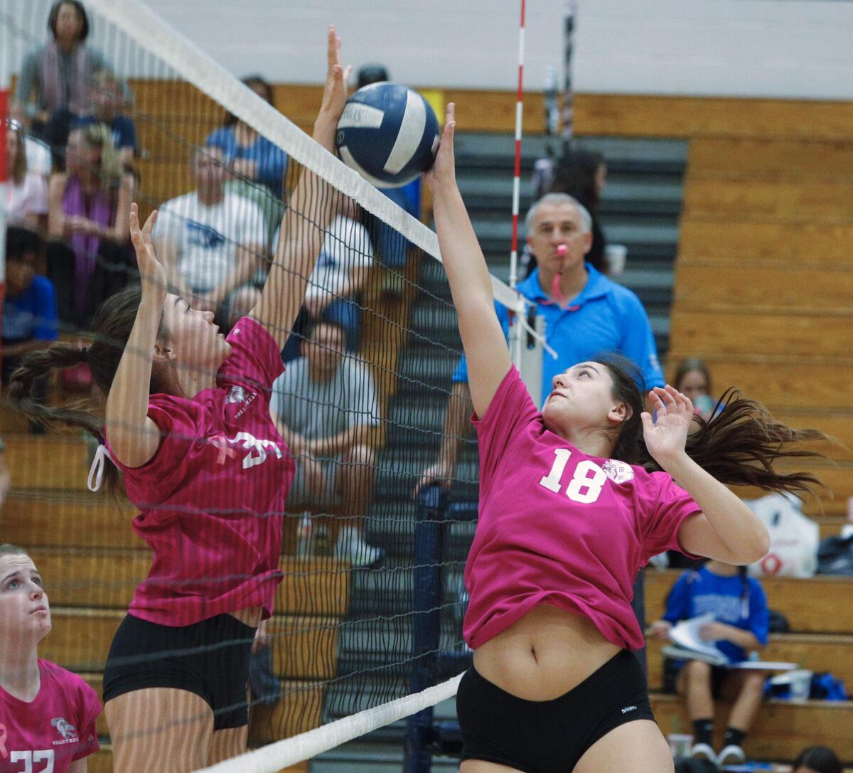 Burbank's Ashley Eskander and Crescenta Valley's Emma Glaza battle at the top of the net for the point in a Pacific League girls' volleyball match at Crescenta Valley High School on Thursday, October 10, 2019.in a Pacific League girls' volleyball match at Crescenta Valley High School on Thursday, October 10, 2019. Both teams wore the exact same color pink jersey in honor of Breast Cancer Awareness month.