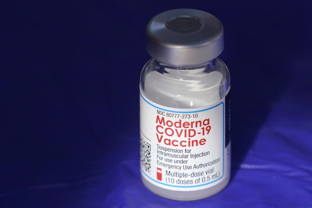 FILE - In this March 4, 2021 file photo, a vial of the Moderna COVID-19 vaccine rests on a table at a drive-up mass vaccination site in Puyallup, Wash., south of Seattle. Moderna’s COVID-19 vaccine brought in more than $4 billion in second-quarter sales, Thursday, Aug. 5, pushing the vaccine developer into a profit. (AP Photo/Ted S. Warren, File)