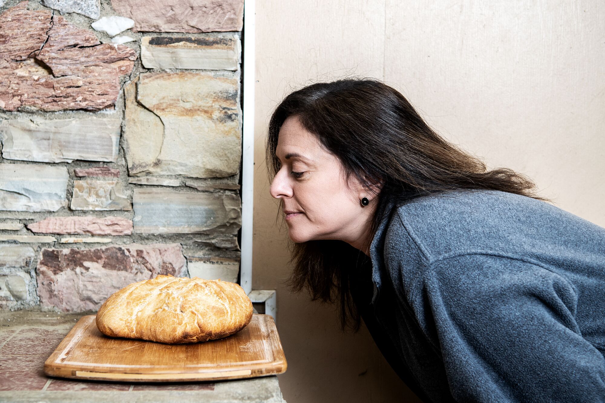 Sharon Lieblein admires her baked bread at her home on April 9.