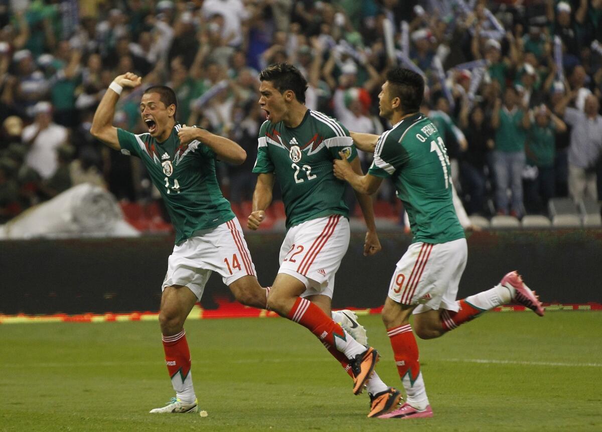 Mexico's Raul Jimenez, center, celebrates with teammates Javier Hernandez, left, and Oribe Peralta after scoring a game-winning goal against Panama on Friday. Mexico likely will qualify for the World Cup with a win over Costa Rica on Tuesday.