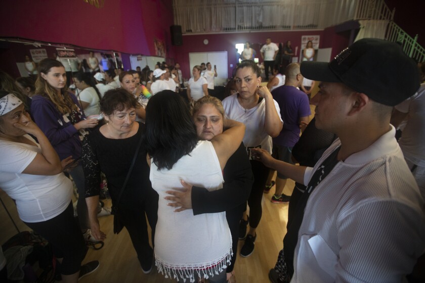 People surround Keyla’s mother Lorena Pimental de Salazar