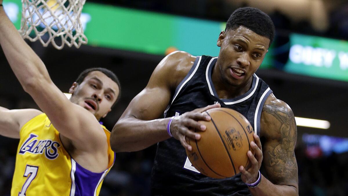 Kings forward Rudy Gay pulls down a rebound against Lakers forward Larry Nance Jr.