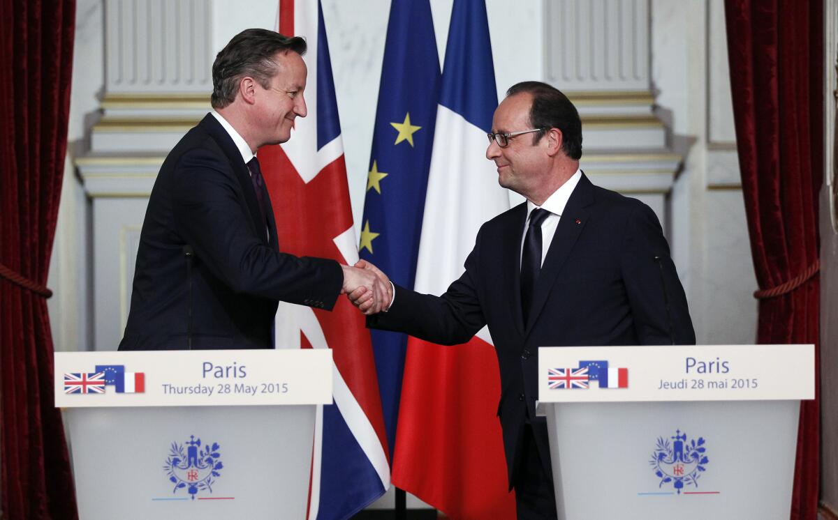 British Prime Minister David Cameron, left, shakes hands with French President Francois Hollande after a press conference at the Elysee Palace in Paris on Thursday.
