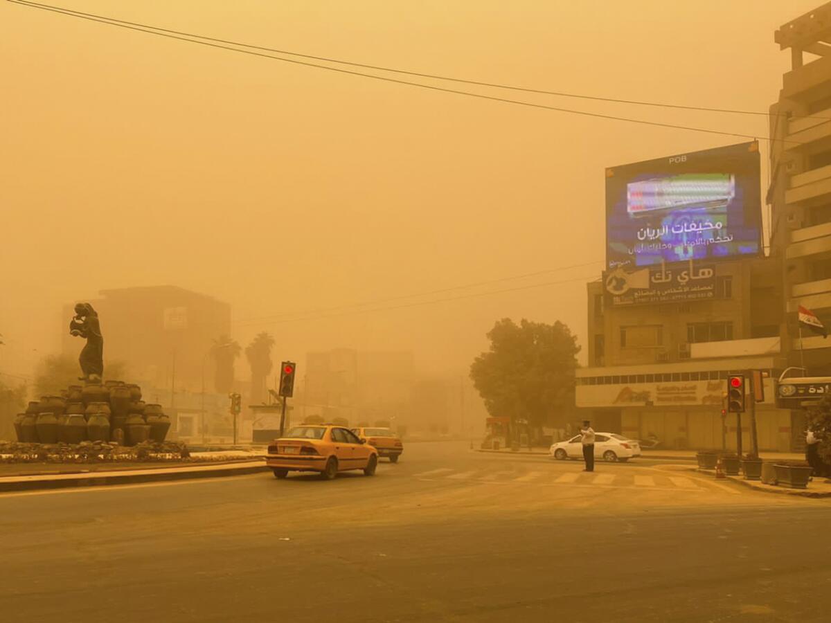 Cars drive through a sandstorm in Baghdad, Iraq