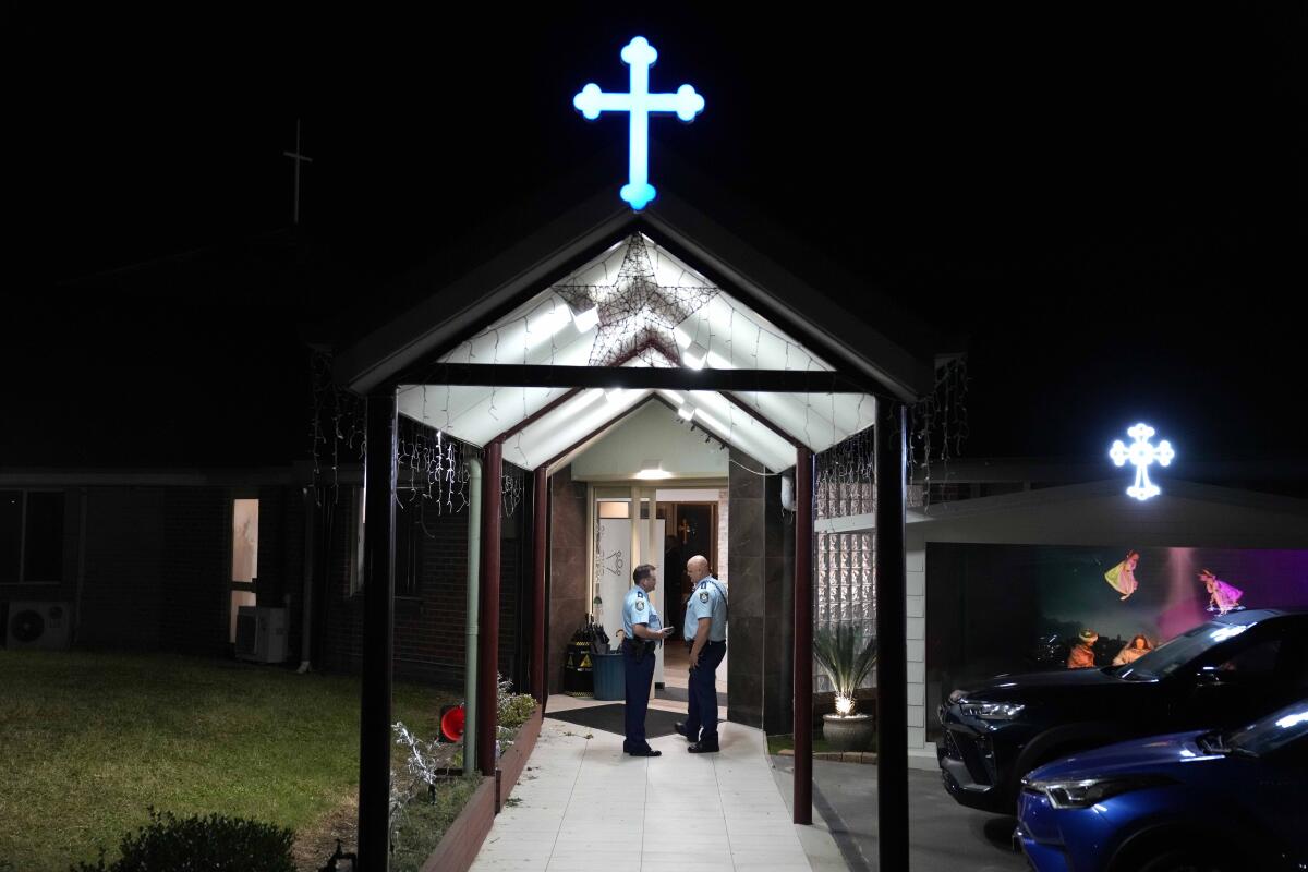 Security officers stand guard outside an Orthodox Assyrian church in Sydney.