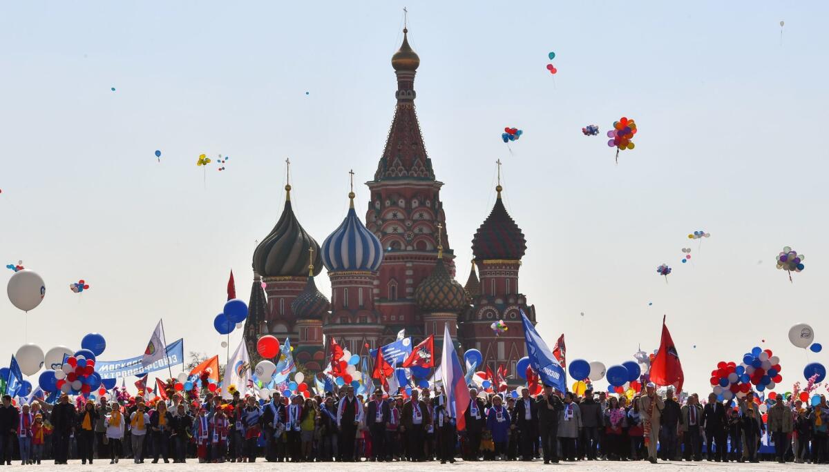 Russian Trade Unions' members holding balloons, flags and artificial flowers parade on Red Square during their May Day demonstration in Moscow . (YURI KADOBNOV / AFP / Getty Images)
