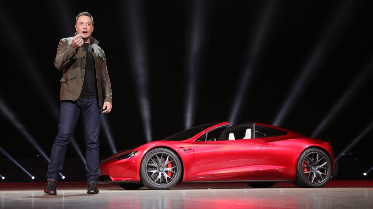 Elon Musk unveils a new Tesla sports car in November 2017. Thousands of buyers are still waiting for delivery of their Model 3 sedans.