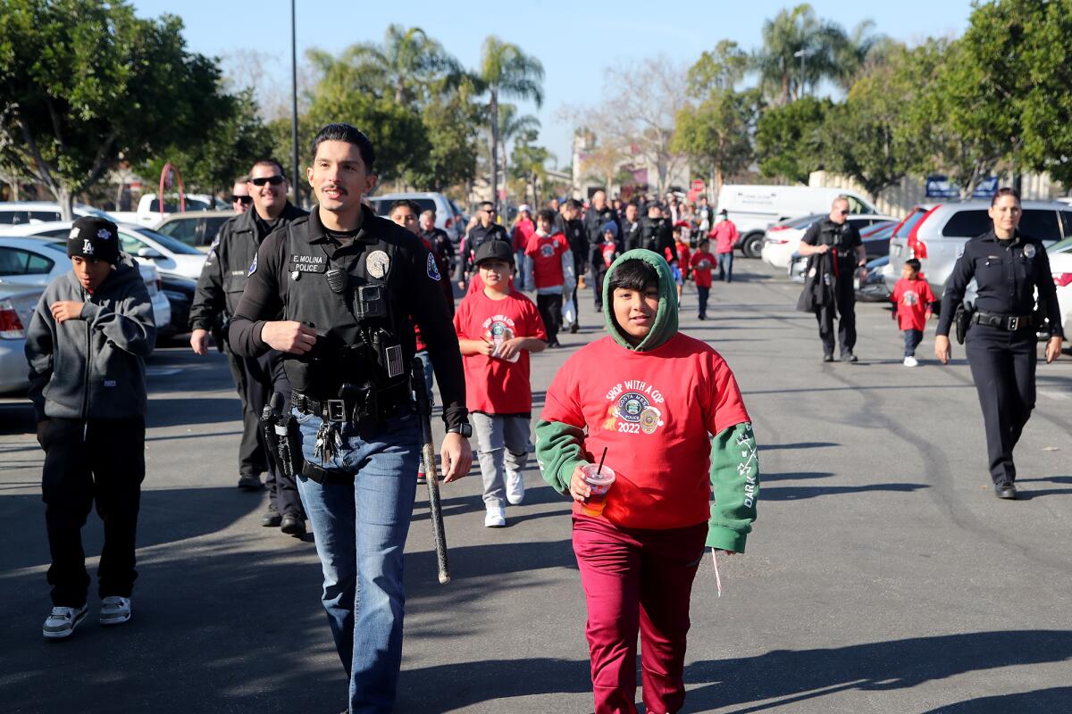 Students and Costa Mesa police make their way to Target for the Shop with a Cop event Wednesday.