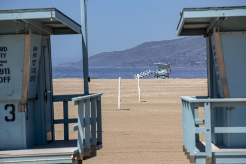 MALIBU, CA - APRIL 23: Lifeguard towers sit on an empty Zuma Beach on Thursday, April 23, 2020 in Malibu, CA. To fend off coronavirus contagion, Los Angeles County has kept beaches closed, but hundreds of beachgoers flaunted the rules up and down the coastline from Santa Monica to Malibu. (Brian van der Brug / Los Angeles Times)