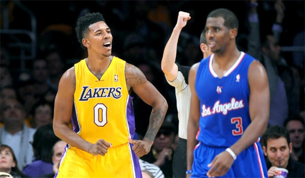 Nick Young celebrates in front of Chris Paul during the Lakers' season-opening victory over the Clippers.
