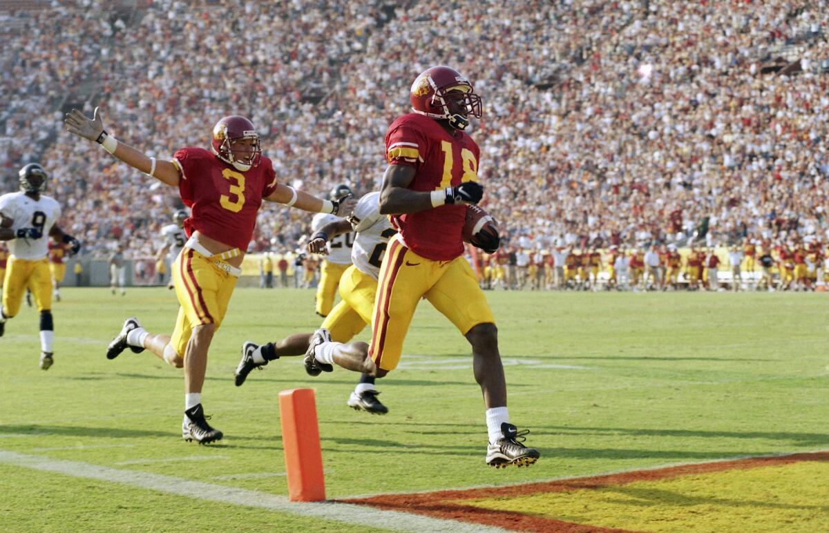 USC receiver R. Jay Soward outruns California defenders, scoring a touchdown as Billy Miller raises his arms nearby.