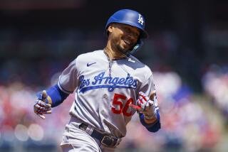 Los Angeles Dodgers' Mookie Betts reacts after his solo home run during the third inning.