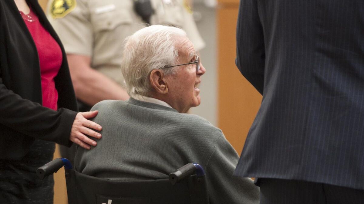 Defense attorney Alicia Freeze had her hand on the back of 92-year-old Richard Peck as they listened to judge Kathleen Lewis during his change of plea hearing.