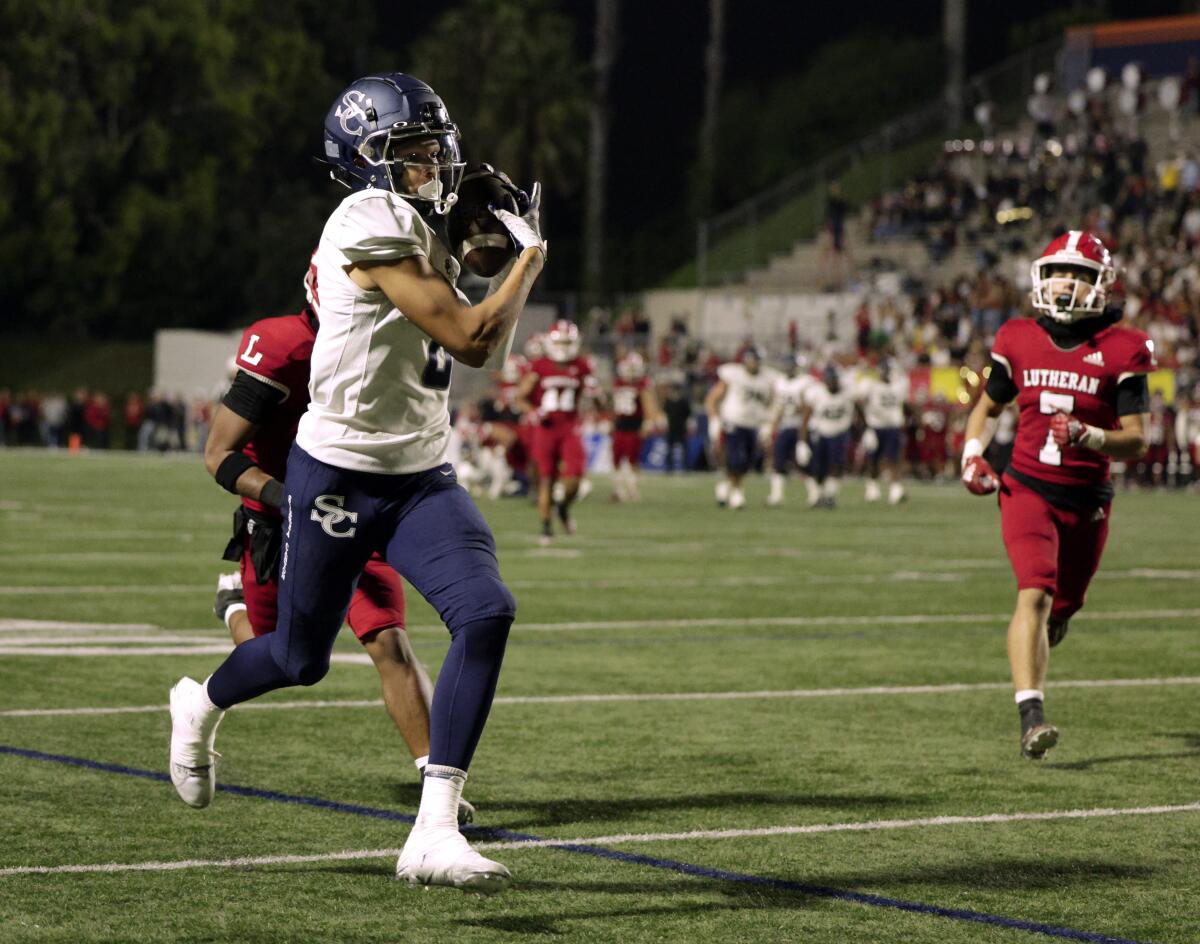 Sierra Canyon receiver Cole Crawford hauls in a 33-yard pass for a touchdown against Orange Lutheran on Friday night.