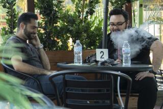 TUJUNGA, CA - JUNE 03: Gamer Aghajani, 28, left, and Mampreh Zadoorian, 28, (NAMES ARE CQ) enjoy a hookah after school and work, respectively, at Garden on Foothill hookah lounge in Tujunga, CA on Thursday, June 3, 2021. Smoking lounge owners are concerned about an L.A. proposal to ban the sale of flavored tobacco products. Under the draft proposal, Los Angeles could exempt existing "legally operating smokers' lounges," permitting them to sell flavored tobacco for consumption on site. But hookah tobacco sellers argue that the exemption is not legally workable and would provide no avenue for people to buy hookah tobacco and smoke it at home. (Myung J. Chun / Los Angeles Times)