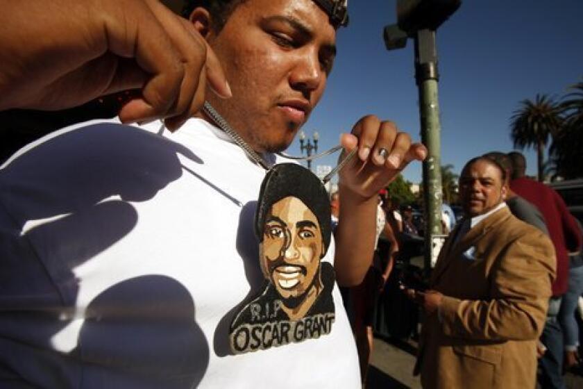 Nigel Bryson, 23, who had been riding the train with Oscar Grant the night he was killed at the BART Fruitvale Station in Oakland on News Years eve in 2009 wears a large pendant painted with Grant's face.